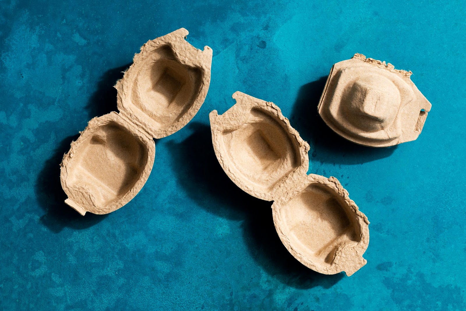 three paper single-egg containers